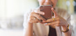 © chinnarach - close up hand hold mobile phone device:focus on trendy girl call text on smartphone concept