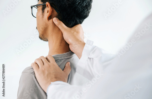 Cuadros en Lienzo Physiotherapist doing healing treatment on man's neck,Chiropractic adjustment, pain relief concept