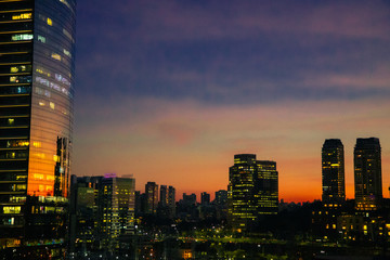 Downtown City sunset warm skyscrapper night dark mirror building business office reflection sun lights tower