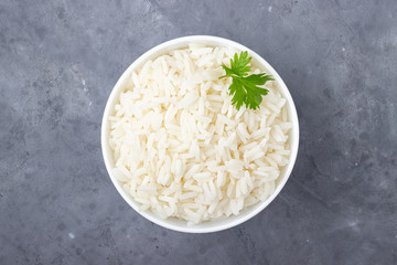 Wall Mural - Boiled rice in a bowl on gray background.