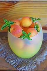 Delicious,sweet apricots and a sprig of mint on the burlap.