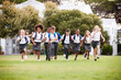 © Monkey Business - Excited Elementary School Pupils Wearing Uniform Running Across Field At Break Time