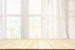 © Piman Khrutmuang - Empty wood table top with window curtain abstract blur background for product display