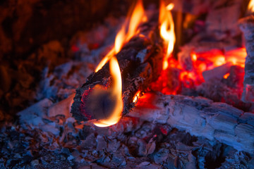 burning logs in the fireplace close up