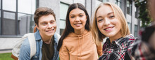 Panoramic Shot Of Happy Teenagers Taking Selfie And Smiling