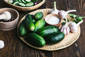 Wall Mural - Bowl of freshly picked organic cucumbers and garlic, fresh vegetables salad