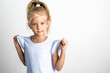 © yakovlevadaria - Beautiful girl with blond hair in a blue dress, a 7 year old child