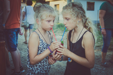 two thirsty girls drinking refreshment drink