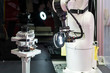 © Surasak - high technology and precision robot grip with automated vision inspection camera for check or measuring product or work piece on table in manufacturing process at factory or work shop