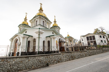 Golden Dome white church on the sky background