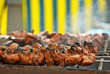 Barbecue fries in the coals. Meat and beef at the field kitchen festival.