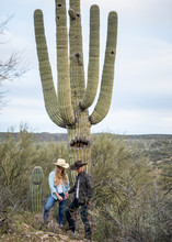 Western Wear Young Married Couple On Desert Ranch Standing By Saguaro