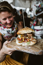 Details Of A Best-ever Cheeseburger While Young Woman Looks At It