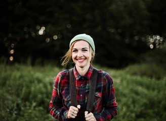 Young beautiful hipster woman standing on field in the countryside
