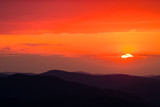 Fototapeta Góry - A wonderful sunset in the mountains. Orange sky and dark silhouettes of mountains. Carpathian Mountains landscape. Bieszczady. Poland