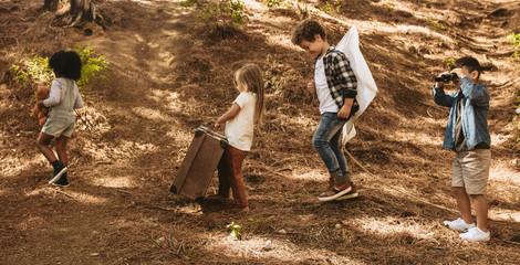 Poster - Group of kids with toys in forest