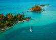 © Cavan Images - A yacht is near a tropical island in Bermuda