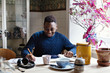 © Maskot - Boy studying at dining table indoors