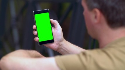 Man reading on a handheld mobile phone