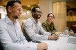 © Maskot - Sales executives smiling during business meeting at conference table in office