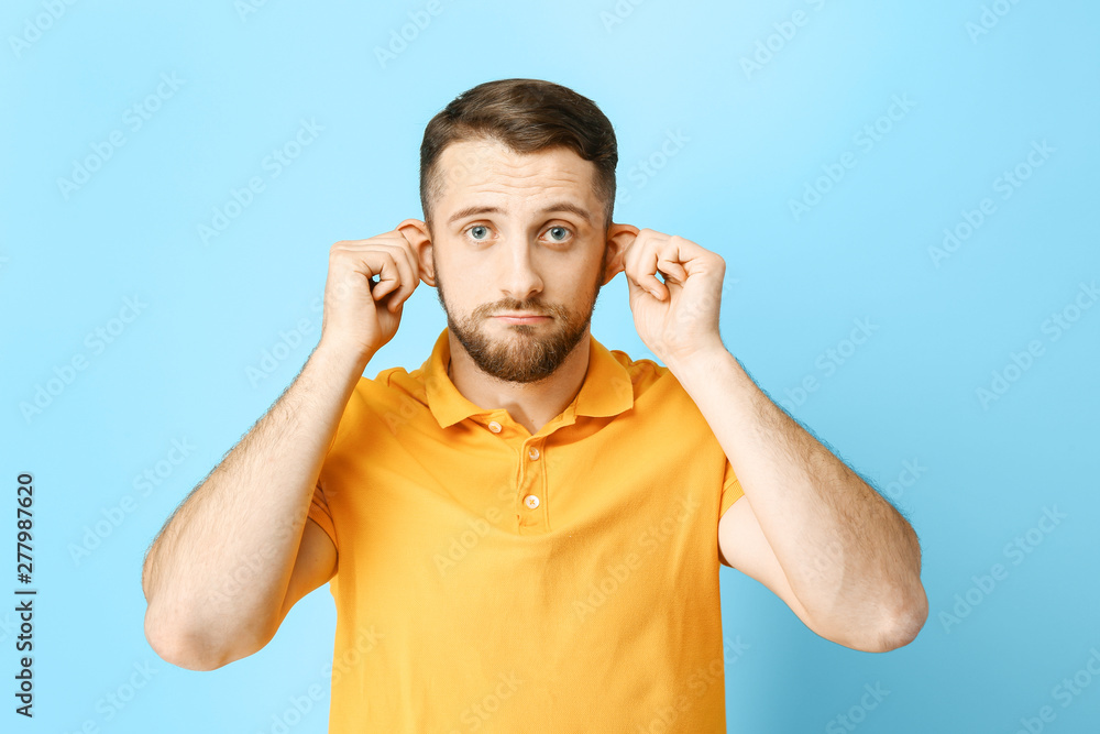 Grimacing man on color background