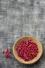 Wall Mural - Fresh organic red currants in a wooden bowl on a dark wooden background, rustic style, top view, horizontal