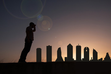 Wall Mural - Traveler facing the skyline of the city of Dallas in the United States