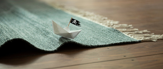 Poster - Paper Boat with Jolly Roger on Carpet Waves