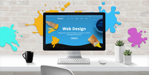 Leinwandbilder - Web design studio with modern web site theme on computer display with color drops on brick wall. Concept of creating modern and colorful web sites.
