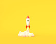 Toy rocket takes off from the books spewing smoke on a yellow background. Symbol of desire for education and knowledge. School illustration. 3D rendering.