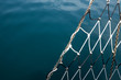 detail fishing net, against blue sea background. Space for text