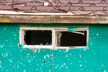 Close Up Of The Small Window With Broken Glass Of An Old And Weathered Shed