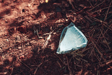 A Piece Of Glass Lies On The Ground And Shines