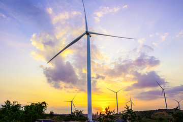 Wall Mural - night scene of landscape mountain view with windmills on the hill with sunset sky, wind turbine gene