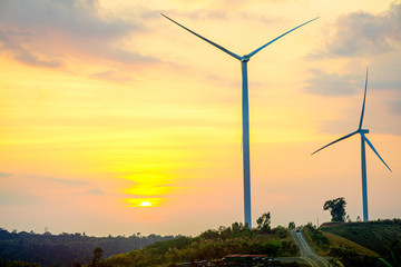 Wall Mural - windmills on the hill with sunset sky, wind turbine generator to build electricity power in rural ar