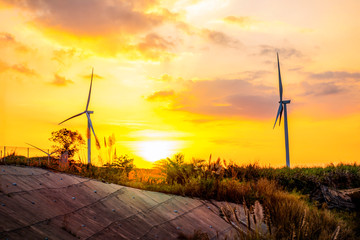 Wall Mural - landscape mountain view with windmills on the hill with sunset sky, wind turbine generator to build 