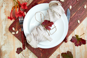 Fall table setting for Thanksgiving day celebration on wooden background. Autumn table setting. Top view. Falt lay. Copy space.