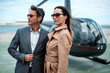 © Nejron Photo - Young business couple near private helicopter