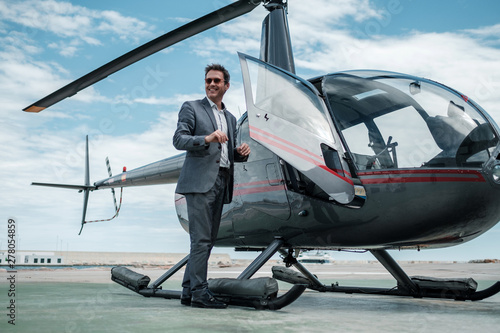Fotografía Businessman standing near private helicopter