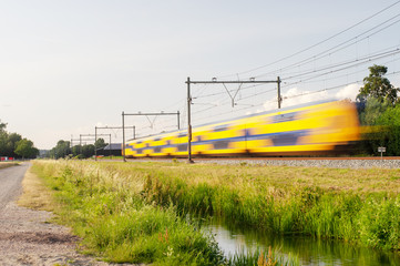 Wall Mural - Dutch railway train with speed, with long exposure.