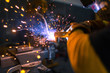© Nikita - Worker welding a metal part using a machine with sparks. close-up.