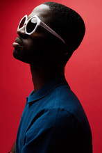 Fashion Portrait Of Black Man In Sunglasses On Red Background