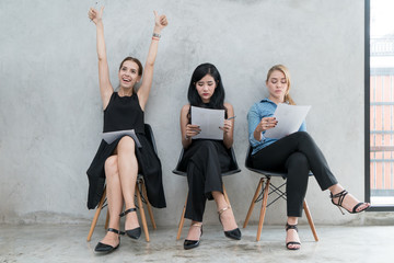 Group of asian and multiethnic business people with casual suit in queue waiting for job interview in modern office. People business group concept.