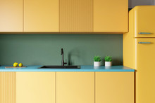 Yellow Countertops In Green Kitchen