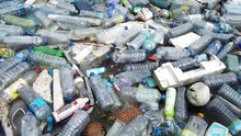 Plastic Pollution Trash In Ocean With Different Kinds Of Garbage - Plastic Bottles, Bags, Wastes Floating In Water. Sea Ocean Water Pollution Concept. Plastic Pollution Crisis