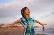 © TheVisualsYouNeed - young beautiful and happy 7 or 8 years old Asian American mixed child girl with wet hair enjoying holidays playing in the sea carefree and opened arms feeling free