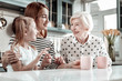 © zinkevych - Friendly women of one family sitting at the kitchen table and talking