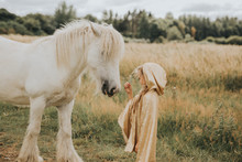 Girl Standing In Front Of White Horse