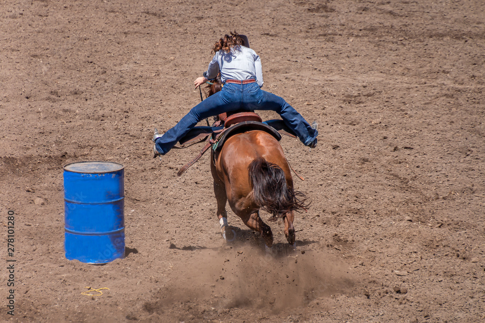 Photo Stock Barrel Racing at a Rodeo, a cowgirl rides a roan colored ...