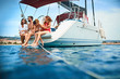 © luckybusiness - Happy people on vacation relaxing on the yacht deck.
